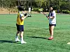 A confused Mary, right, concentrates on learning proper passing technique from a patient Kyu-min. [MARY YANG]