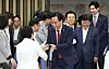 Rep. Song Eon-seog, emergency committee interim leader and floor leader of the conservative People Power Party, center, greets lawmakers ahead of a party meeting at the National Assembly in western Seoul on July 3. [YONHAP]