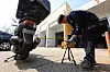 A motorcycle is being checked on April 28 in western Seoul. The license plate is stuck at the rear end of the vehicle. [YONHAP]