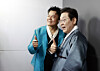 President Lee Jae Myung, right, and JYP Entertainment founder and co-chair of the newly established Presidential Committee on Popular Culture Exchange Park Jin-young pose for photos at the K-culture exhibition zone inside Kintex in Goyang, Gyeonggi, on Oct. 1. [JOINT PRESS CORPS]