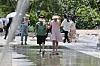 Children cool off under a fountain tunnel in Gwanghwamun Square in Jongno District, central Seoul, on June 5. [YONHAP]