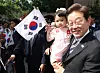 President Lee Jae-myung holds up a baby in front of their home in Gyeyang District, Incheon, on June 4. [JOINT PRESS CORPS]