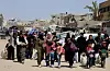 Palestinians make their way with belongings as they flee their homes after the Israeli military issued orders for evacuation from eastern Khan Younis, in the southern Gaza Strip on May 19. [REUTERS/YONHAP]