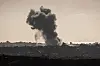 This picture taken from the Israeli side of the border with the Gaza Strip shows smoke plumes rising above destroyed buildings following Israeli strikes in the northern Gaza Strip on May 19. [AFP/YONHAP]