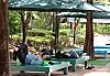 People rest under a large parasol in Witgol Park in Jangan, Gijang County, Busan, to escape the heat on June 4. [YONHAP]