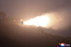 North Korea’s Missile Administration, alongside the Academy of Chemical Materials, conducts a ground jet test of a high-thrust solid-fuel engine using carbon fiber composite material on Sept. 8, observed by North Korean leader Kim Jong-un. [YONHAP]