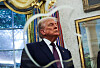 U.S. President Donald Trump looks on as he and Apple CEO Tim Cook present Apple's announcement of a $100 billion investment in U.S. manufacturing, in the Oval Office at the White House in Washington on Aug. 6. [REUTERS/YONHAP]