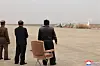 This image from the Korean Central News Agency on Nov. 15, 2024, shows North Korean leader Kim Jong-un, center, overseeing a test of suicide attack drones produced by local firms. [YONHAP]