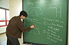 Baek Jin-eon, a researcher at the June E Huh Center for Mathematical Challenges at the Korea Institute for Advanced Study, explains the moving sofa problem. [KOREA INSTITUTE FOR ADVANCED STUDY]