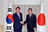 President Yoon Suk Yeol, left, and Japanese Prime Minister Fumio Kishida shake hands during their bilateral talks in Washington on July 10, on the margins of the NATO summit. [JOINT PRESS CORPS]