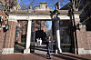 A passerby walks through a gate to the Harvard University campus in Cambridge, Massachusetts, on Jan. 2, 2024. [AP/YONHAP]