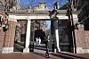 A passerby walks through a gate to the Harvard University campus in Cambridge, Massachusetts, on Jan. 2, 2024. [AP/YONHAP]