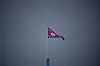 A North Korean flag flutters at the propaganda village of Gijungdong in North Korea, in this picture taken near the truce village of Panmunjom inside the demilitarized zone separating the two Koreas, South Korea on July 19, 2022. [REUTERS/YONHAP]