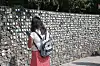 An adoptee reads nametags of adoptees at a monument in Paju, Gyeonggi, on June 14. [YONHAP]