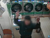 A middle school student poses in front of a security camera after stealing from an unmanned laundry shop in Seoul. [SCREEN CAPTURE]