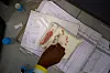 A pharmacist counts HIV medicine inside a clinic in Ha Lejone, Lesotho, on July 16. [AP/YONHAP]