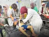 Medics at Specialized Field Kuwaiti Hospital rush to evacuate and treat a number of wounded, including children, after Israeli airstrikes targeted an area sheltering displaced families in the southern Gaza Strip on July 12. More than 100 Palestinians, including women and children, were killed in widespread Israeli airstrikes on the Gaza Strip. [UPI/YONHAP]