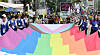 Participants at the Seoul Queer Culture Festival carry a large rainbow flag representing the LGBTQ community near Myeongdong Cathedral in Jung District, central Seoul, on June 14. [NEWS1]
