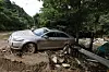 A car is seen submerged in mud as a landslide triggered by heavy rainfall swept the region in Mail-ri, Jojong-myeon, Gapyeong County, Gyeonggi, on July 21. [JUN MIN-KYU]