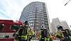 Firefighters look up at the Seoul Center Building in Jung District, central Seoul, after extinguishing a blaze there on the morning of Oct. 21. [NEWS1]