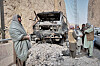 Local officials confer next to a burned-out truck that caught fire from power cables as they try to reach affected areas during a powerful 6.3-magnitude earthquake in a rural part of the Khulm District in Samangan Province, northern Afghanistan, on Nov. 3. [AP/YONHAP]