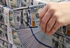 A banker checks dollar bills at Hana Bank's Counterfeit Notes Response Center in Seoul on Nov. 5, 2025. [YONHAP]