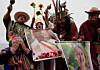 Peruvian shamans perform rituals while holding images of Mexico's President Claudia Sheinbaum and Chilean candidate Jeannette Jara, as Peru faces a diplomatic rift with Mexico and Chile heads toward a presidential runoff, in Lima, Peru, on Dec. 12. [REUTERS/YONHAP]