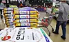 Shoppers examine bags of rice at a large supermarket in Seoul on Oct. 12 as rice prices continue to surge. [NEWS1]