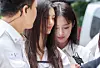 Members Danielle, left, and Minji of girl group NewJeans enter the Seoul Central District Court building in southern Seoul to attend a mediation session on Aug. 14, 2025. [NEWS1]
