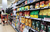 A shopper selects coffee products at a supermarket in Seoul on Jan. 7. [YONHAP]