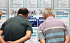 Job seekers look at notices posted at a job fair in Suwon, Gyeonggi, on July 9. [NEWS1]