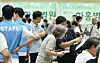 Job seekers look at notices posted at a job fair in Suwon, Gyeonggi, on July 9. [WOO SANG-JO]