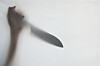 A person holding a knife. Image is unrelated to the story. [GETTY IMAGES BANK]