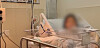 A woman surnamed Kim is seen in a hospital in Guam after giving birth via cesarean section in this image taken from Korean broadcaster MBC's report. [SCREEN CAPTURE]