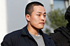 Police officers escort Terraform Labs co-founder Do Kwon after he served a sentence for document forgery, in Podgorica, Montenegro, March 23, 2024. [REUTERS/YONHAP]