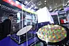 Visitors examine a semiconductor wafer at the Semiconductor Exhibition held at Coex, Gangnam, in October 2023. [NEWS1]