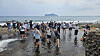 Participants of Jeju National University's 2025 learncation program pose for a photo at a beachside wading area. [JEJU NATIONAL UNIVERSITY]