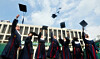 Students throw their graduation caps at the Sungkyunkwan University campus in Jongno District, central Seoul, on Aug. 25, the day of the university's commencement ceremony. [YONHAP]