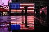 People walk past a display of the U.S. flag in Times Square on April 11 in New York. [AFP/YONHAP]