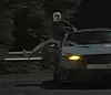 A drag racing suspect performs a stunt while hanging from the passenger seat. [GYEONGGI NAMBU PROVINCIAL POLICE]