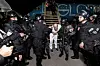 Salvadoran police officers escort alleged members of the Venezuelan gang Tren de Aragua recently deported by the U.S. government to be imprisoned in the Terrorism Confinement Center (Cecot) prison, as part of an agreement with the Salvadoran government, at the El Salvador International Airport in San Luis Talpa, El Salvador, in this handout image obtained on March 16. [REUTERS/SECRETARIA DE PRENSA DE LA PRESDIENSIA]