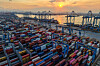 Containers are stacked at the port in Qingdao during a sunset on Aug. 18. [AFP/YONHAP]