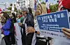 Civic organization members hold a protest in central Seoul on April 10 demanding the government disclose information related the people who were adopted to families in foreign countries. [YONHAP]