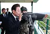 President Lee Jae Myung observes the North through binoculars in Yeoncheon County, Gyeonggi, on June 13. [YONHAP]