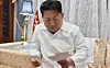 In this image captured from a documentary about Hyon Chol-hae, former senior advisor to the Ministry of National Defense and Marshal of the Korean People’s Army, North Korean leader Kim Jong-un cries while reading letters exchanged with Hyon [YONHAP]