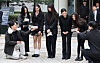 NewJeans members, from left, Hanni, Minji, Hyein, Haerin and Danielle, speak to reporters after attending a court hearing on March 7 at the Seoul Central District Court in Seocho District, southern Seoul. [YONHAP]