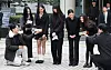 NewJeans members, from left, Hanni, Minji, Hyein, Haerin and Danielle, speak to reporters after attending a court hearing on March 7 at the Seoul Central District Court in Seocho District, southern Seoul. [YONHAP]