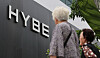 People walk past the HYBE headquarters building in Yongsan District, central Seoul, on May 30, 2024. [NEWS1]