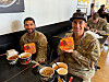 This undated photo, provided by Nongshim, shows U.S. soldiers at Fort Bliss in Texas holding the company's Shin Ramyun products at a Cupbop franchise outlet located within the base. [YONHAP]