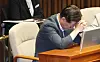 Democratic Party leader Lee Jae-myung sits with his head in his hands during a plenary session of the National Assembly in Seoul on Wednesday. [YONHAP]